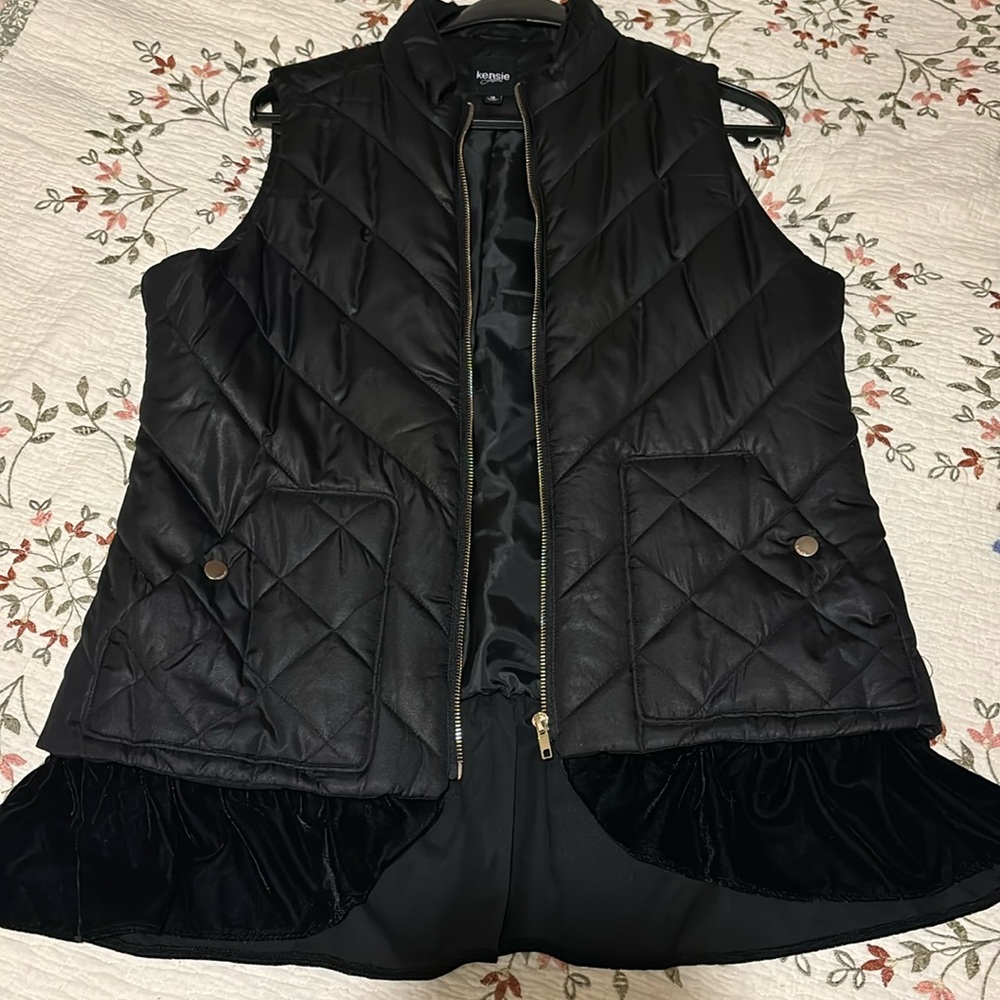 Women’s lined puffer vest with velvet ruffle to look like layers.